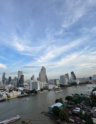 Cityscape with tall buildings along a river.