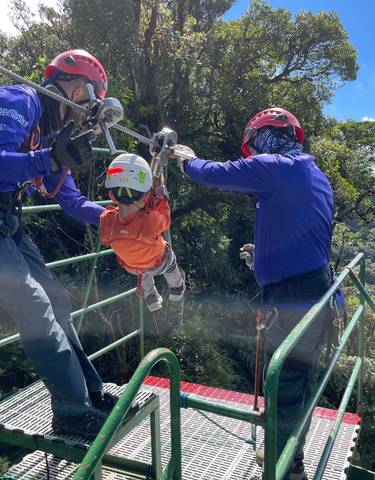 People engaging in a zip-lining activity.
