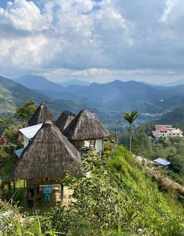 Mountainous landscape with traditional huts.
