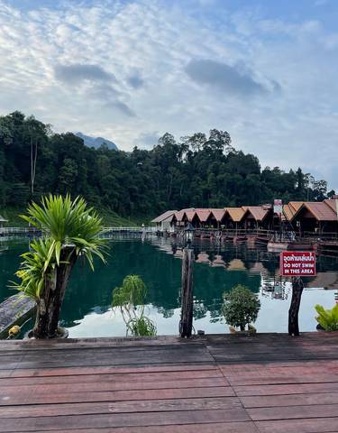 Floating lodges on a lake surrounded by jungle.