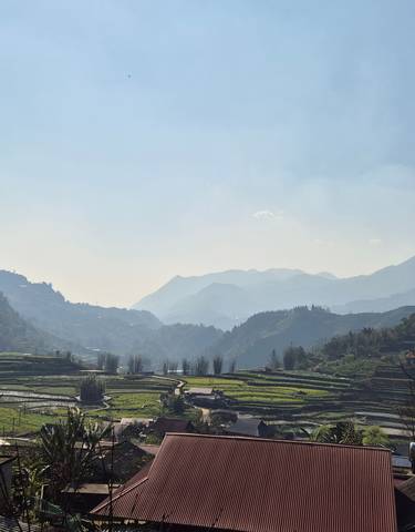 Panoramic view of rice terraces and mountains.