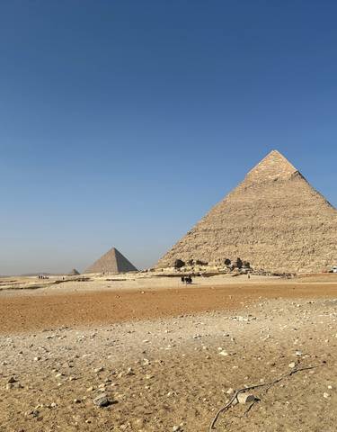 The Pyramids of Giza under a clear blue sky.