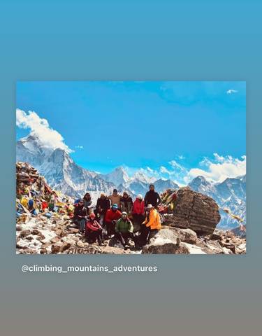 Group photograph with Himalayan mountain backdrop.