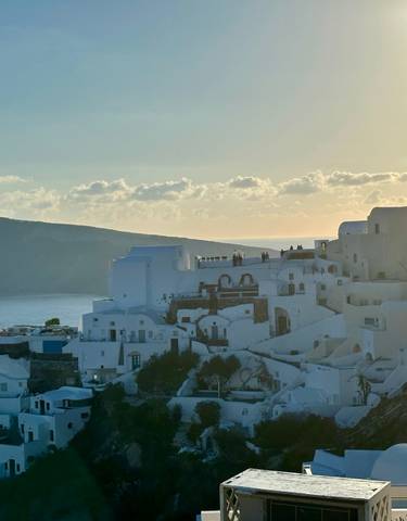 Santorini buildings at sunset with sea view.