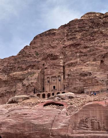 Ancient carved stone structures in a desert setting.