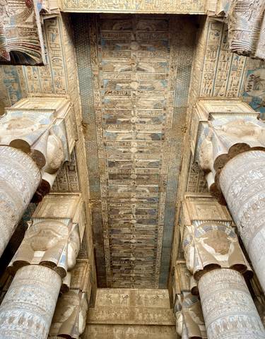 Ceiling of temple with detailed carvings and paintings.