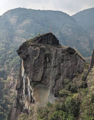 Large rock formation with a bamboo bridge