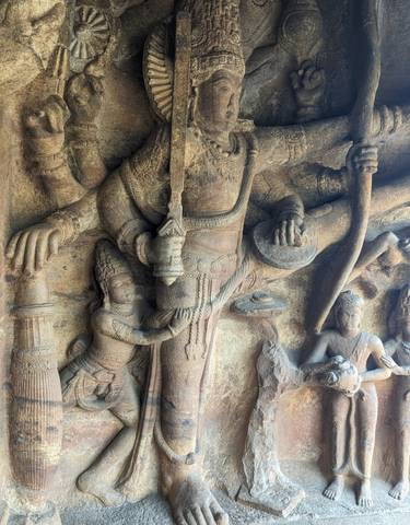 Ancient stone sculptures depicting Hindu deities with intricate carvings.