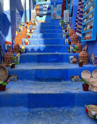 Blue painted stairs with pots and decorations.