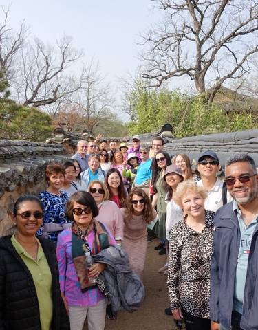 Group of tourists walking through a traditional alleyway.