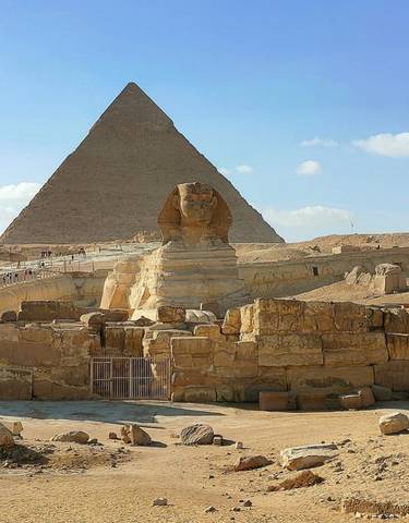 Famous ancient Sphinx statue before a large pyramid.