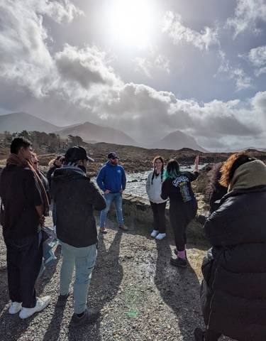 Group of people with mountains in the background.