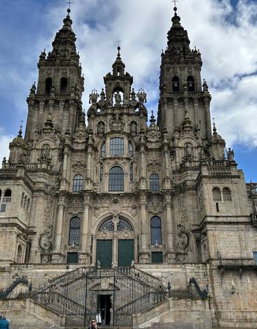 A grand cathedral with detailed architecture against a blue sky.