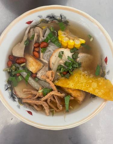 Bowl of Vietnamese noodle soup with ingredients.