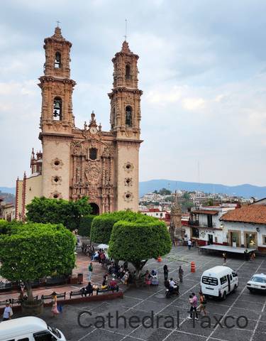 Ornate church surrounded by the town of Taxco.