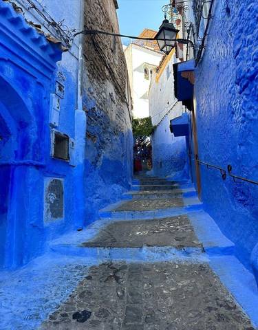 A narrow alley painted in bright blue.