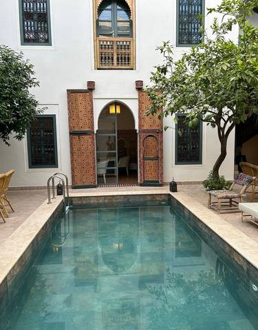 Courtyard with a small pool and trees.