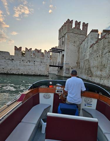 Boat approaching a fortification wall from the water