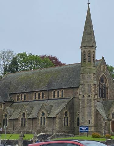 Historic stone church building with a pointed roof