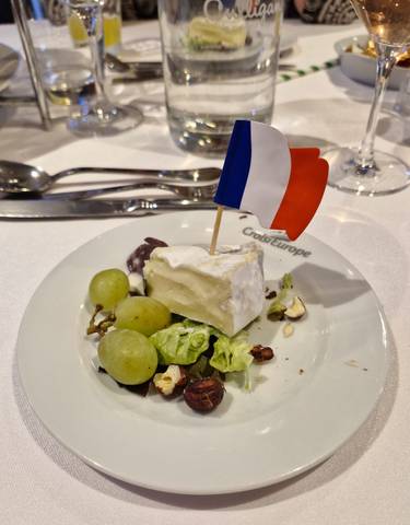Plate of cheese and grapes with a French flag