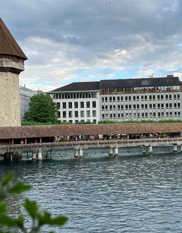Historic wooden bridge over a water canal.