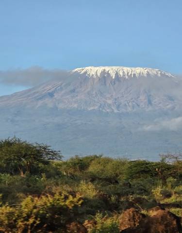 Mount Kilimanjaro peeking through clouds.
