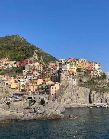 Colorful cliffside village overlooking a rocky shore