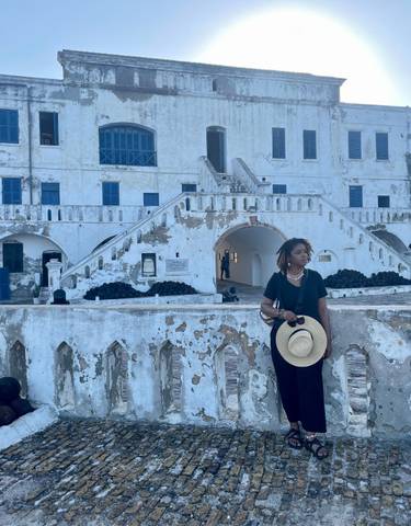Woman in front of Cape Coast Castle.