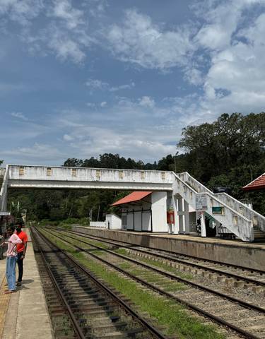 Train station platform in Ella with people waiting.