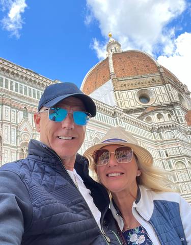 Two people posing in front of the Florence Cathedral.
