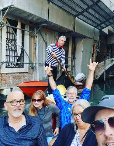 Group enjoying a gondola ride in a Venetian canal.