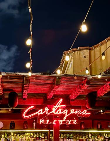 Night scene with illuminated Cartagena sign.