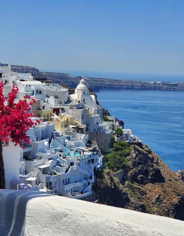 Picturesque seaside town with classic white and blue architecture.