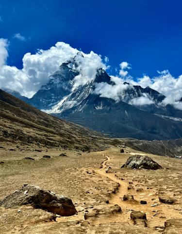 Majestic mountain view under partly cloudy skies.