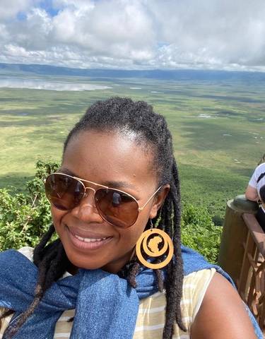 People overlooking a vast green landscape.