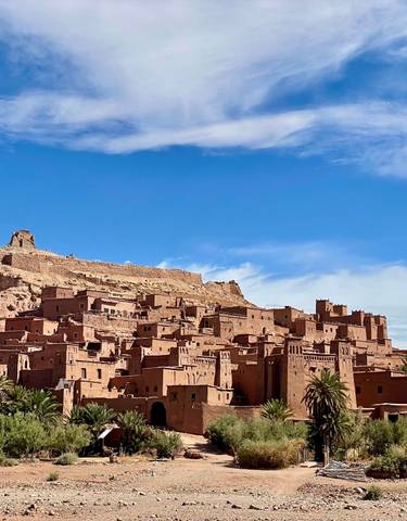 Historical fortified village with desert backdrop.