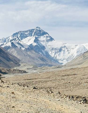 Vast mountainous landscape with snow-covered peaks.
