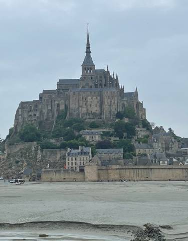 Medieval abbey on an island at low tide.