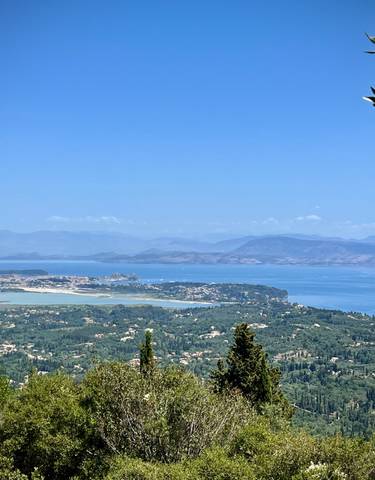 Scenic view of a coastline with hills and blue sea.