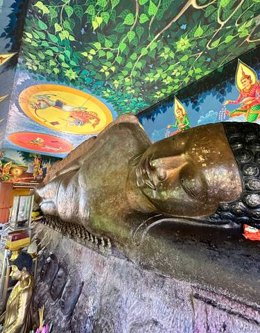 Reclining Buddha statue inside a temple.