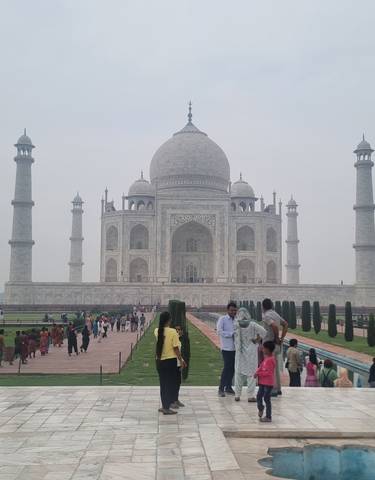 The Taj Mahal with tourists in the foreground.