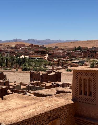 Mudbrick town with desert background and blue sky.