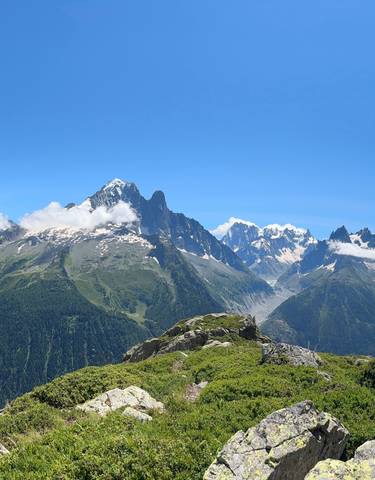 Panoramic view of mountain range with green valleys.