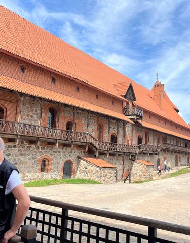 Trakai Castle in Lithuania with visitors nearby.