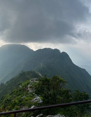 Mountainous landscape under a cloudy sky.