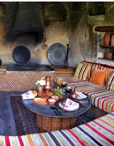 Indoor setup with traditional seating and food served on a low table