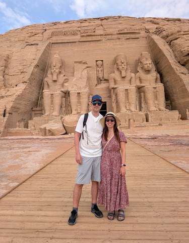 Tourists posing in front of the Abu Simbel temples in Egypt.