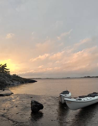 Kayak on the shore during a beautiful sunset.