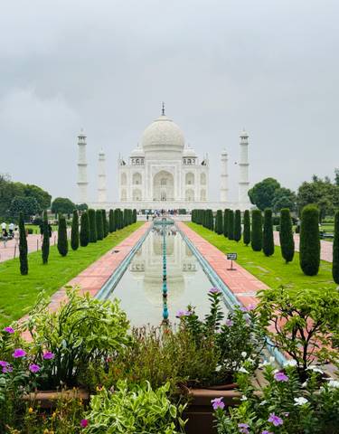 The iconic view of the Taj Mahal with its reflection in the water.