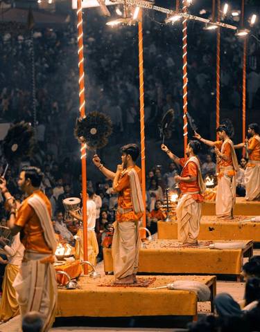 People performing a ceremony with lit up surroundings.
